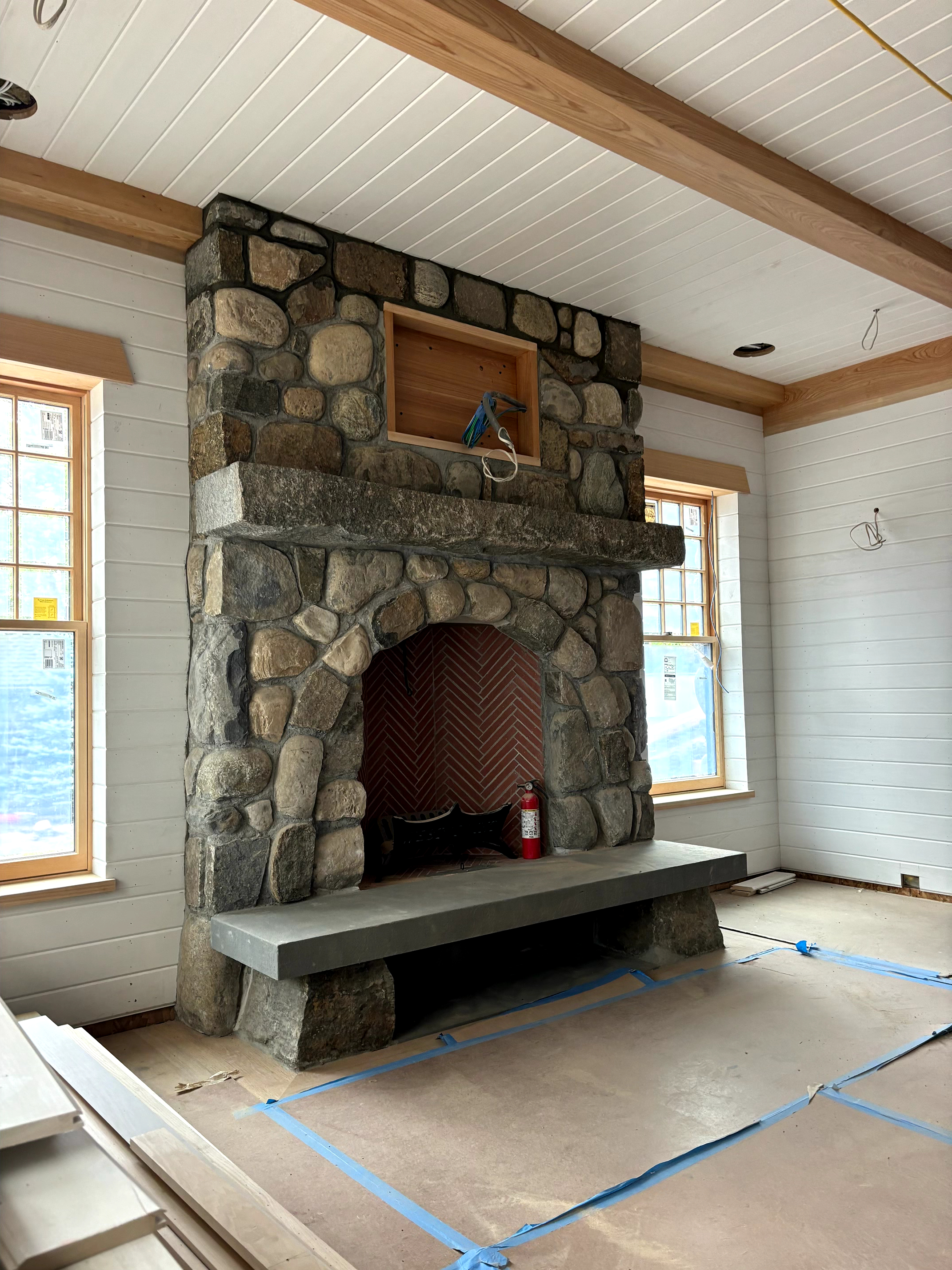 River rock fireplace with bluestone hearth