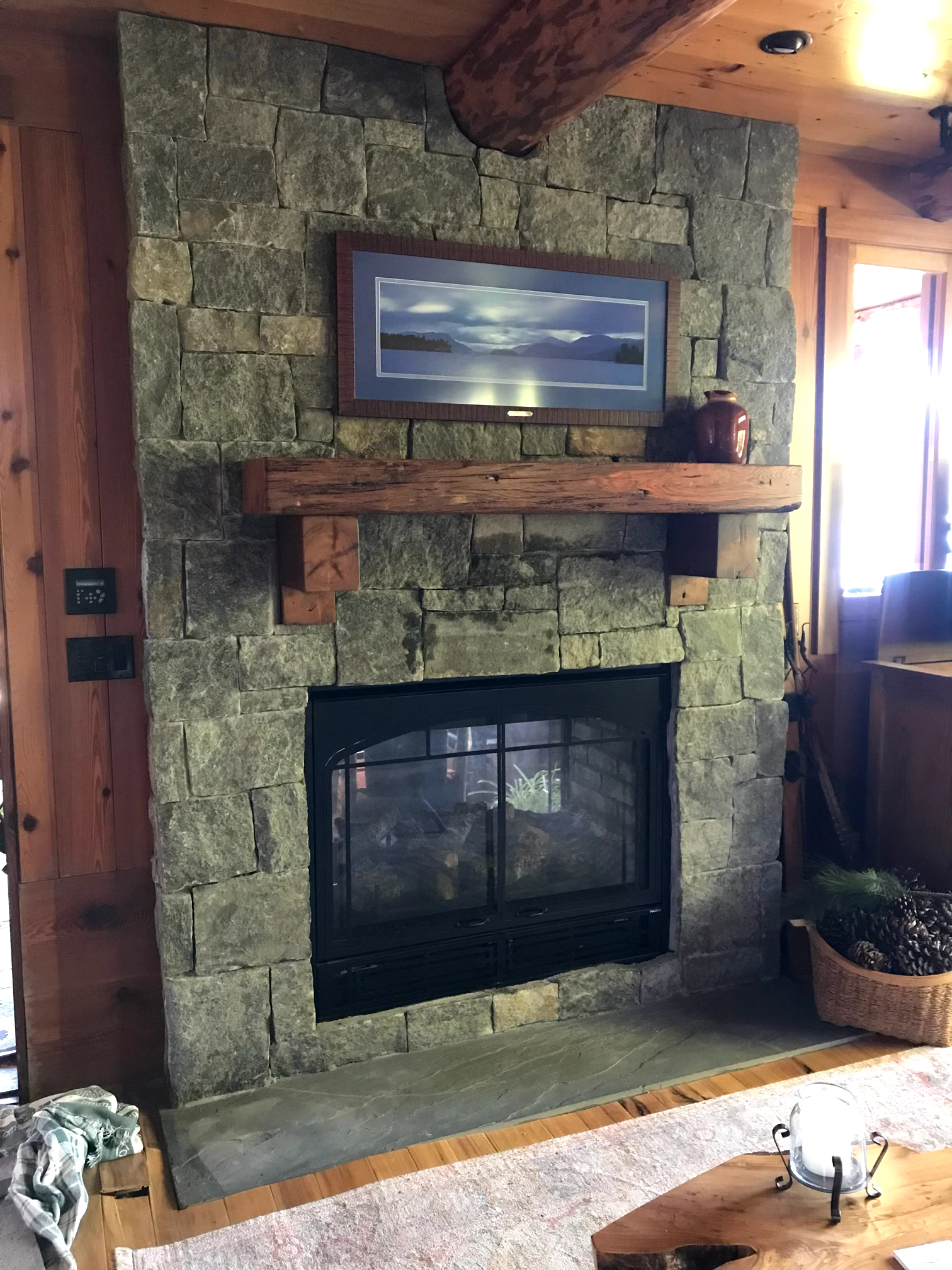 Stone fireplace in log cabin